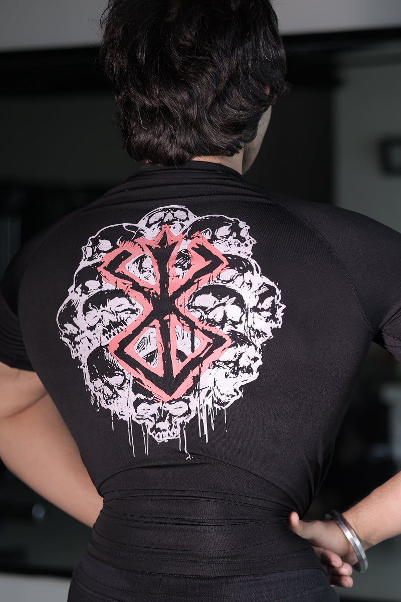 Person wearing a black compressio tshirt with a pink and white graphic design on the back.